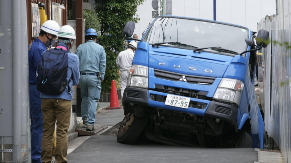 Garbage truck partly swallowed by sinkhole in Tokyo's Kichijoji